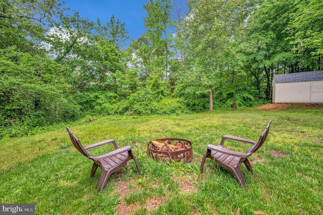 55 Hamn, Stafford, VA 22554 - view of yard featuring an outdoor fire pit, an outdoor structure, and a storage unit