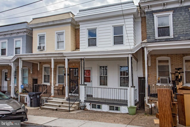 view of property with cooling unit and a porch