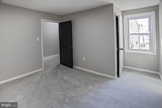 unfurnished bedroom featuring carpet and baseboards