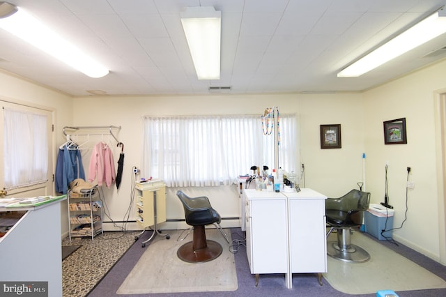 miscellaneous room featuring baseboards, visible vents, and a baseboard radiator