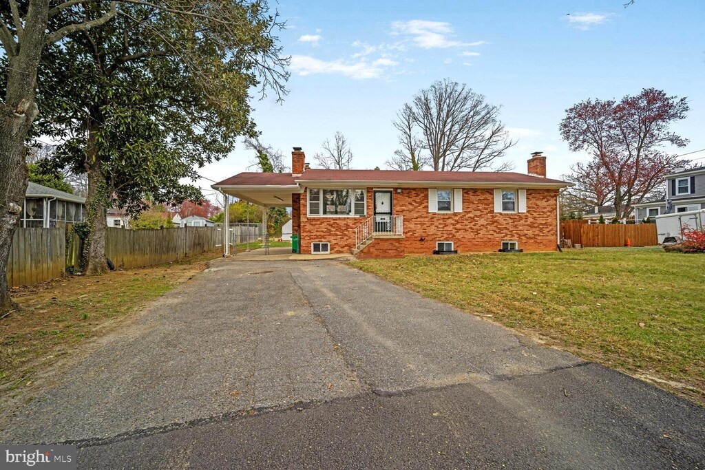 5006 Mathilda Ln, Suitland, MD 20746 - view of front of home with driveway, a chimney, an attached carport, and fence