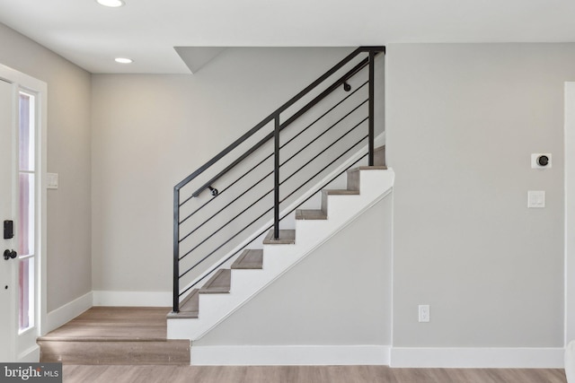 entryway featuring stairs, recessed lighting, wood finished floors, and baseboards