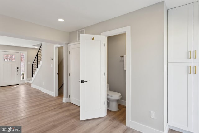 bathroom with toilet, recessed lighting, baseboards, and wood finished floors