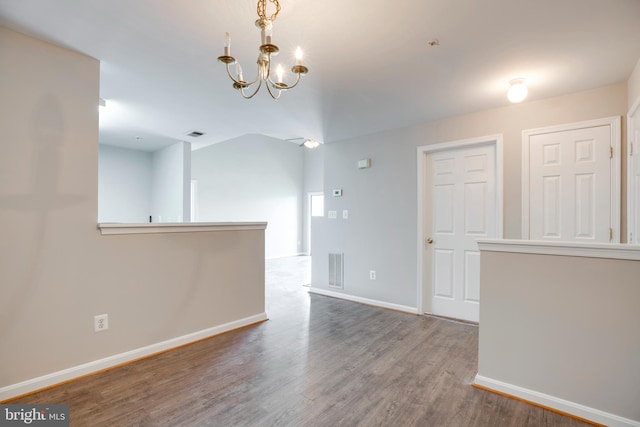 1055 Gardenview Loop Unit 402, Woodbridge, VA 22191 - unfurnished room featuring visible vents, baseboards, a notable chandelier, and wood finished floors