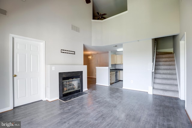 1055 Gardenview Loop Unit 402, Woodbridge, VA 22191 - unfurnished living room featuring visible vents, a ceiling fan, dark wood-style floors, stairs, and a glass covered fireplace