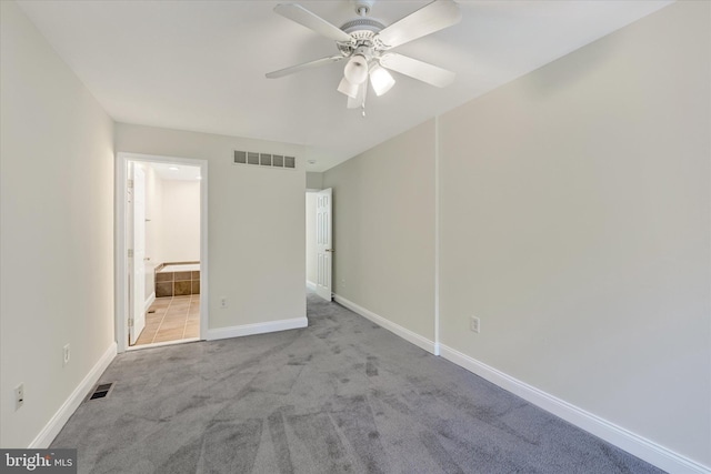 unfurnished bedroom featuring carpet flooring, baseboards, and visible vents