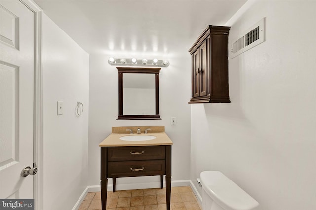 bathroom with baseboards, visible vents, toilet, and vanity