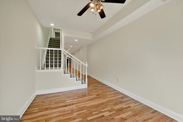 staircase with baseboards, wood finished floors, recessed lighting, and a ceiling fan