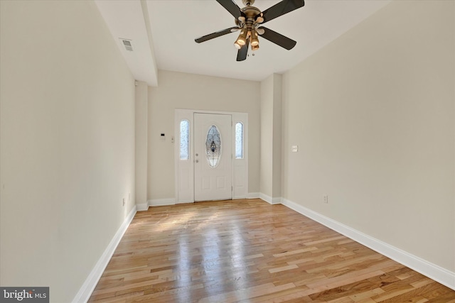 entryway with baseboards, visible vents, light wood-style flooring, and ceiling fan