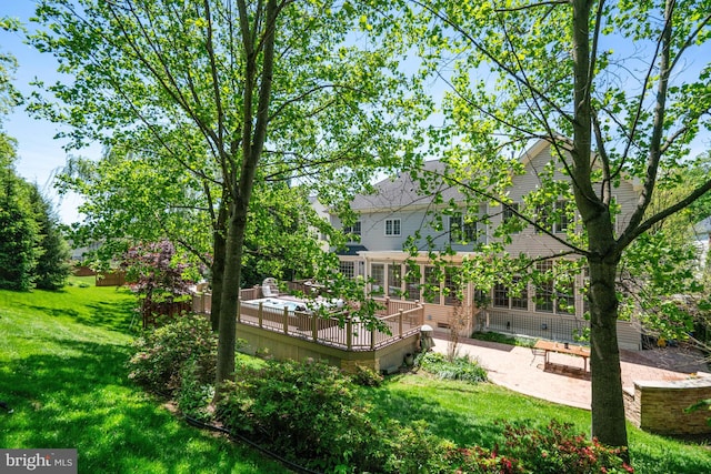 exterior space with a lawn, a patio area, and a deck