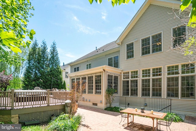 back of property featuring a patio area, a wooden deck, and crawl space