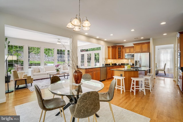 dining room featuring light wood-style floors, recessed lighting, and a notable chandelier