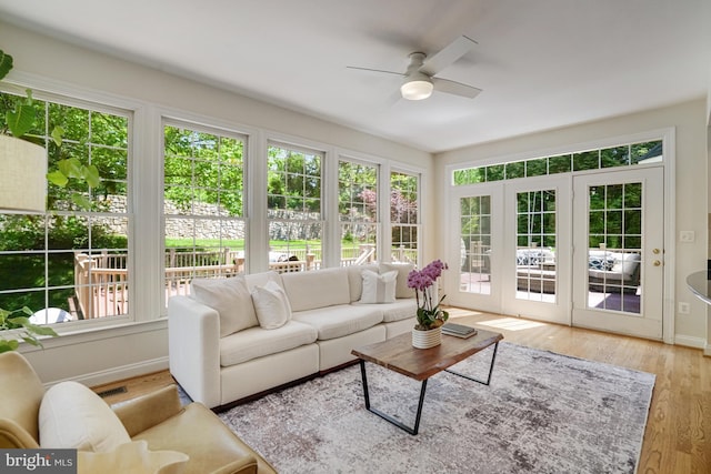 sunroom with french doors, baseboards, and wood finished floors