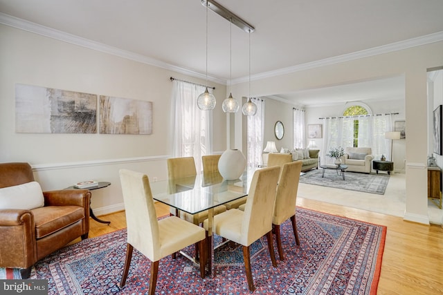 dining room featuring crown molding and wood finished floors