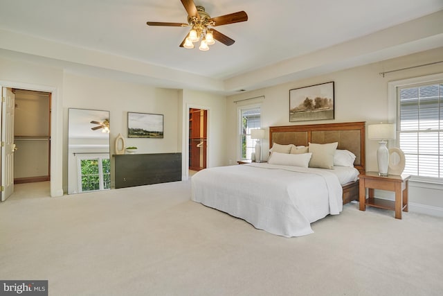 bedroom featuring carpet floors, multiple windows, and a spacious closet