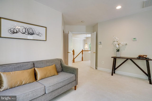 living room with visible vents, recessed lighting, baseboards, and light colored carpet