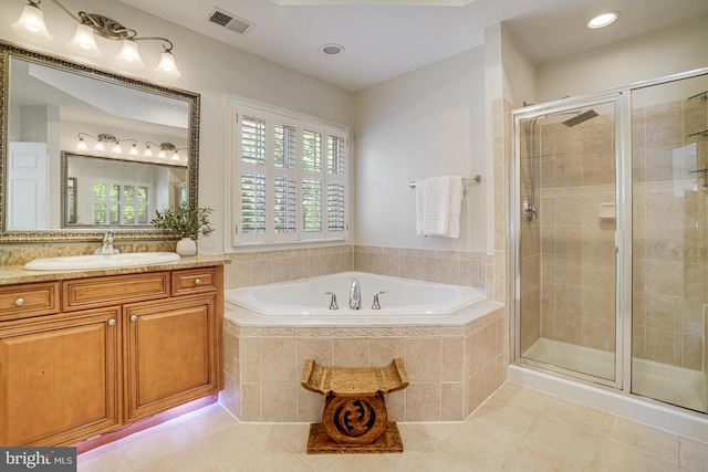bathroom featuring tile patterned flooring, a stall shower, a garden tub, and visible vents