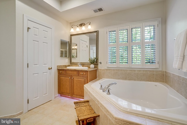 bathroom featuring visible vents, tile patterned flooring, a garden tub, and vanity