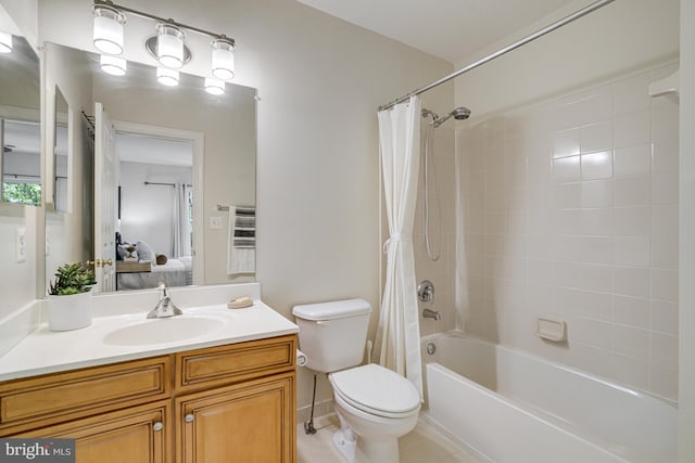 ensuite bathroom featuring vanity, toilet, ensuite bathroom, tile patterned floors, and shower / tub combo