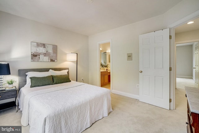 bedroom featuring recessed lighting, baseboards, light carpet, and ensuite bathroom