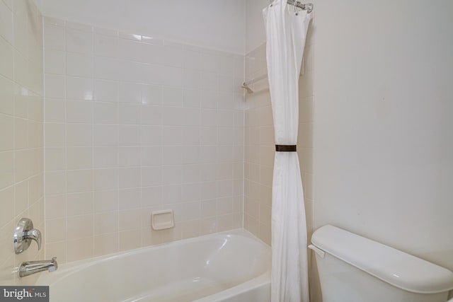 full bath featuring toilet and shower / bath combination with curtain