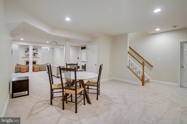 dining room with stairway, recessed lighting, and light colored carpet