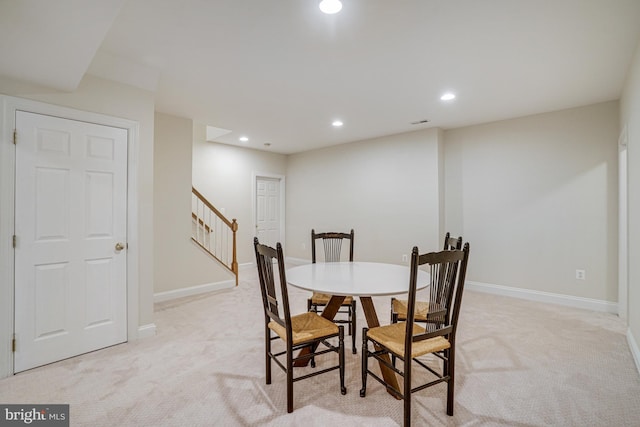 dining space featuring recessed lighting, baseboards, stairs, and light colored carpet