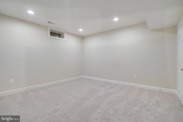 finished below grade area featuring recessed lighting, baseboards, and light colored carpet