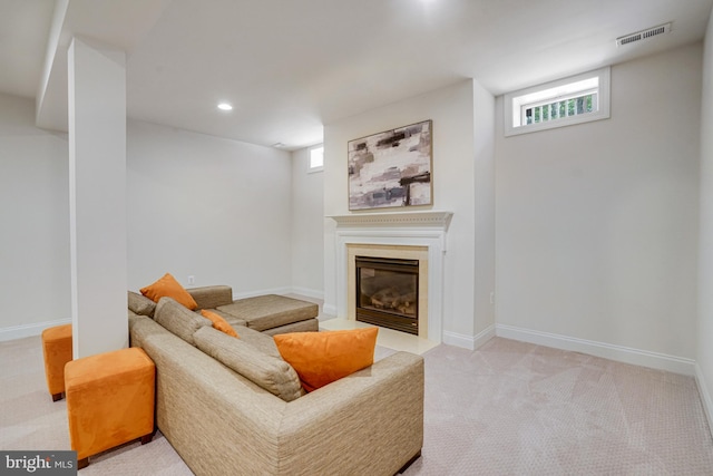 living area with visible vents, a fireplace with flush hearth, baseboards, light carpet, and recessed lighting