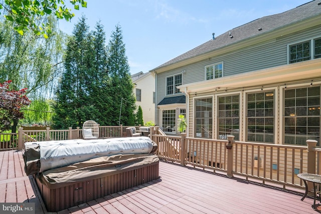 deck with a covered hot tub