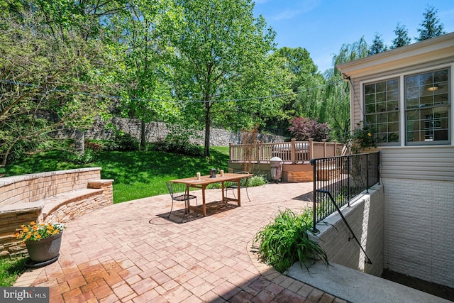 surrounding community with outdoor dining area, a patio area, and a lawn