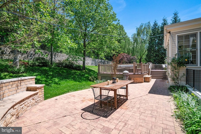 view of patio featuring a deck and outdoor dining space