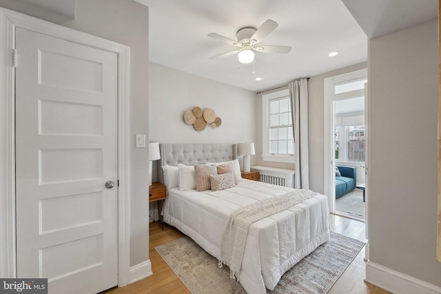 bedroom with baseboards, recessed lighting, ceiling fan, and light wood-style flooring