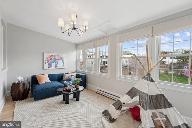interior space featuring a baseboard radiator, wood finished floors, and baseboards