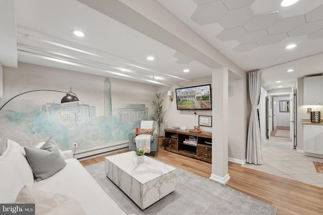 living area with a baseboard radiator, recessed lighting, light wood finished floors, and baseboards