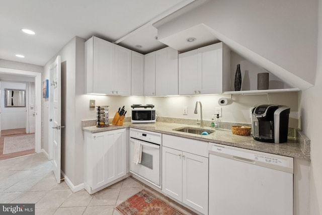 kitchen featuring a sink, light tile patterned flooring, open shelves, white cabinetry, and white appliances