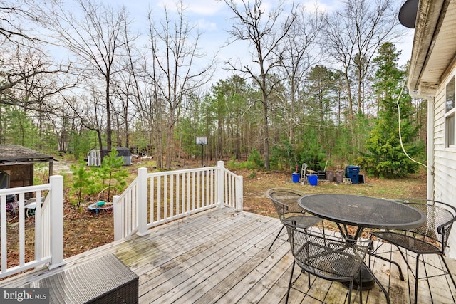 wooden terrace with outdoor dining space