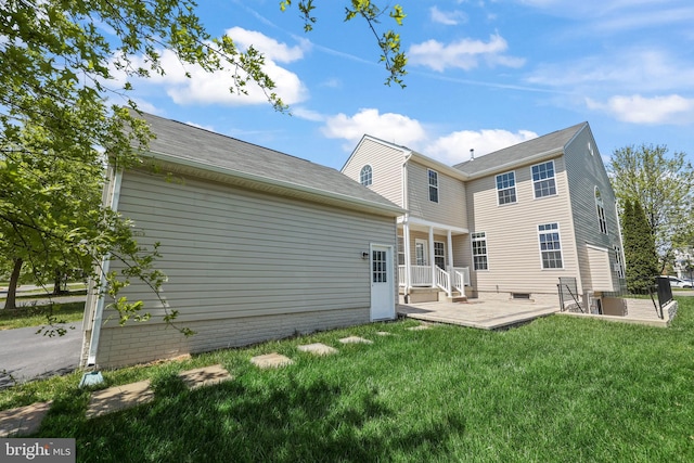 back of house with a yard and a patio