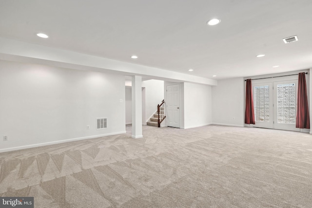 below grade area with visible vents, carpet flooring, and recessed lighting