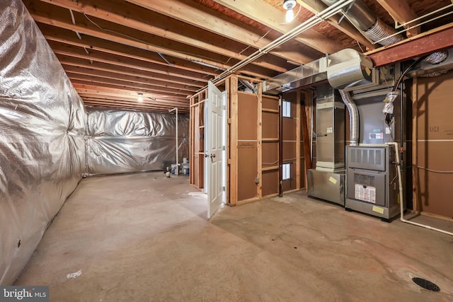 unfinished basement featuring heating unit