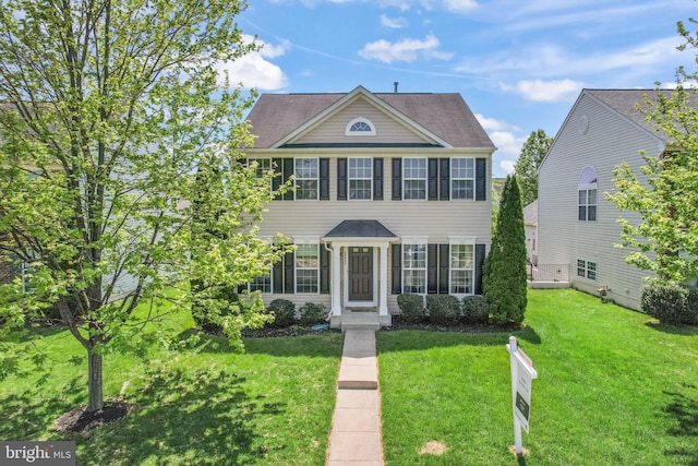 colonial-style house with a front lawn