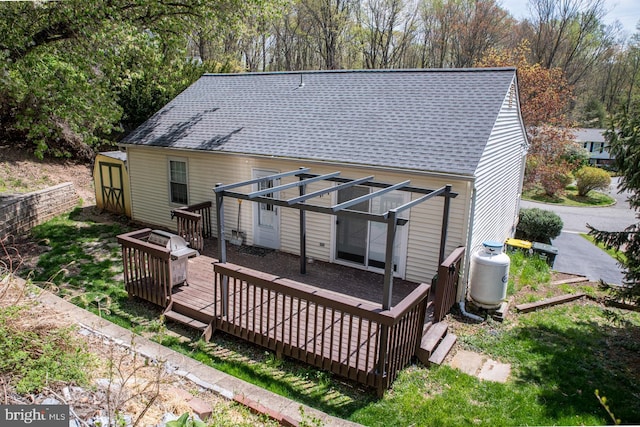 1200 Price Ln, Downingtown, PA 19335 - rear view of property with a storage unit, a wooden deck, a shingled roof, an outdoor structure, and an outdoor fire pit