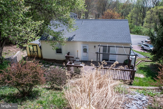 1200 Price Ln, Downingtown, PA 19335 - back of house with a shingled roof, an outdoor structure, and a storage shed
