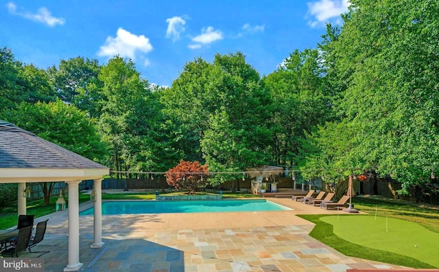view of swimming pool with a patio, a fenced backyard, a fenced in pool, and a gazebo