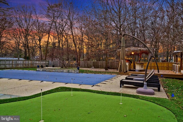 2504 Sherwood Hall Ln, Alexandria, VA 22306 - pool at dusk with a deck and a fenced backyard
