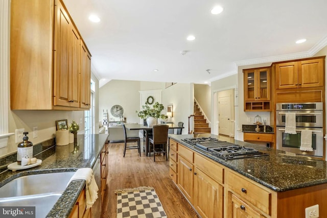 kitchen featuring crown molding, double oven, wood finished floors, and black gas cooktop