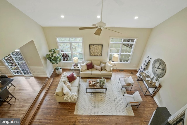 living room featuring baseboards, a ceiling fan, recessed lighting, and wood finished floors