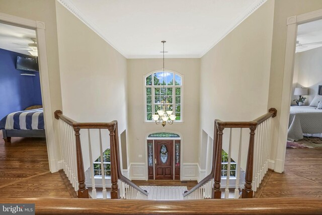 2504 Sherwood Hall Ln, Alexandria, VA 22306 - entrance foyer with crown molding, ceiling fan with notable chandelier, and wood finished floors