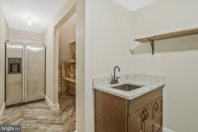 2504 Sherwood Hall Ln, Alexandria, VA 22306 - bar featuring stainless steel fridge, baseboards, indoor wet bar, and a sink