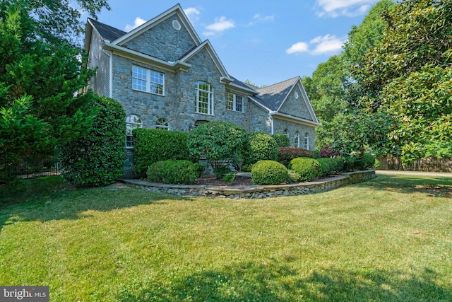 view of home's exterior featuring a yard and stone siding